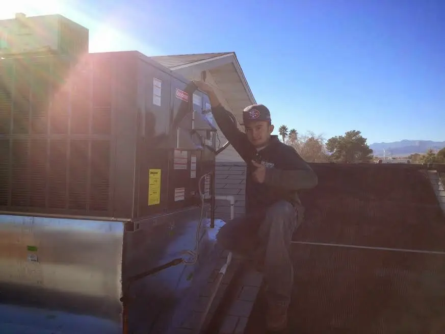 HVAC technician performing HVAC Inspection on a rooftop unit in Susanville